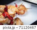 Traditional, oriental and Asian kebabs on a wooden skewer of grilled chicken pieces boiled rice as a garnish. 71120467