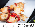 Traditional, oriental and Asian kebabs on a wooden skewer of grilled chicken pieces boiled rice as a garnish. 71120468