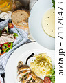 Top view of a restaurant table served with a multi-course set lunch and drink. Complex lunch. 71120473