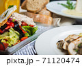 Top view of a restaurant table served with a multi-course set lunch and drink. Complex lunch. 71120474