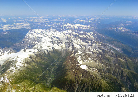The view from the airplane window on a picturesque mountains landscape The view from the airplane window on a picturesque mountains landscape 71126323