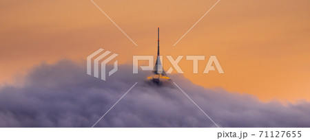 Jested tower partly hidden in the clouds. Dramatic evening atmosphere. Liberec, Czech Republic Jested tower partly hidden in the clouds. Dramatic evening atmosphere. Liberec, Czech Republic 71127655
