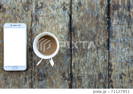 Smartphone and Coffee cup made of paper on old wood desk on top view. 71127951