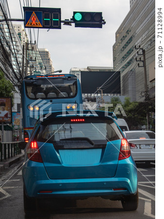 Cars stand at semaphore lights in the city streets. Traffic in downtown Bangkok, Thailand. 71128994
