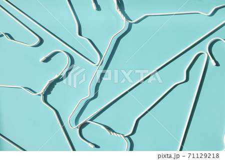 White metal hangers on pastel background White metal hangers on pastel background 71129218