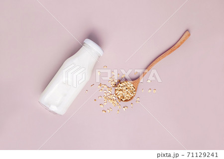 Bottle of non dairy oat milk on pink background 71129241