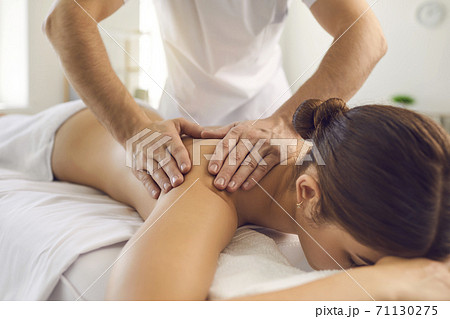 Hands of professional chiropractor or masseur making massage of back and shoulders for woman 71130275