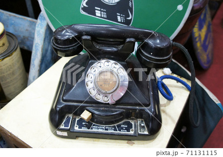 SEREMBAN, MALAYSIA -JUNE 5, 2020: Antique pull dial round phones are on display for sale at the pawn shop. The phone is still in its original condition and well maintained. SEREMBAN, MALAYSIA -JUNE 5, 2020: Antique pull dial round phones are on display for sale at the pawn shop. The phone is still in its original condition and well maintained. 71131115