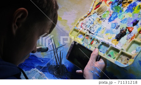 Artist copyist paint seascape with ship in ocean. Craftsman decorator draw as boat sail on blue sea. In hand of cellphone tablet computer pc. 71131218