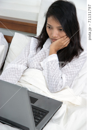 woman with laptop in bed woman with laptop in bed 71131797