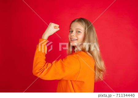 Portrait of young caucasian woman with bright emotions isolated on red studio background Portrait of young caucasian woman with bright emotions isolated on red studio background 71134440