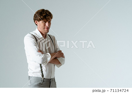 Young foxy man with hands folded on chest. Isolated on white background. Copy space. Young foxy man with hands folded on chest. Isolated on white background. Copy space. 71134724