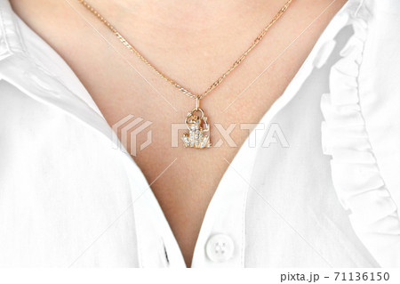 young woman wearing golden frog pendant with gems 71136150