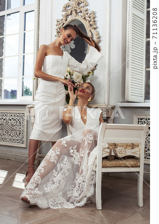 young pretty lady in white lace fashion style dress posing in rich interior of royal hotel room, luxury lifestyle people concept, bride on wedding day 71136208