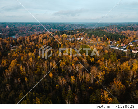 Aerial view: Small lonely church among autumn trees in countryside in Europe 71138028