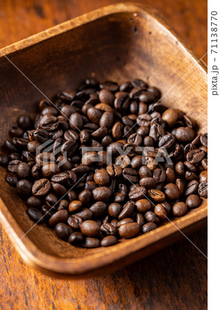 Roasted coffee beans in wooden bowl 71138770