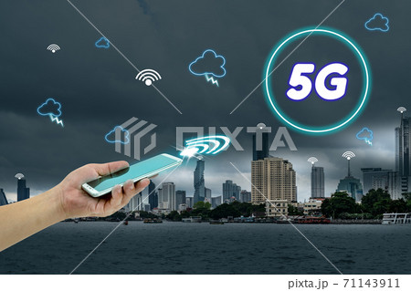 hand holding mobile smart phone with cityscape,5G network interface and icon concept 71143911