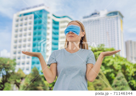 Improper wearing of mask concept. Woman wearing mask wrong Improper wearing of mask concept. Woman wearing mask wrong 71146344