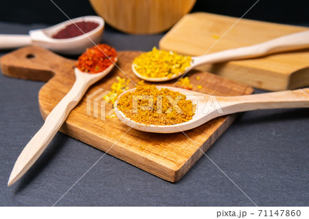 spices in a wooden bowl close-up on a brown wooden background. selective focus spices in a wooden bowl close-up on a brown wooden background. selective focus 71147860