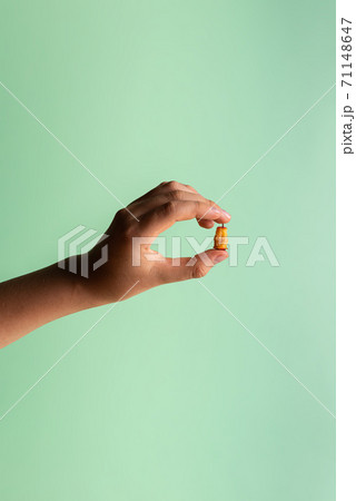 Boy hand with haw stump in fingers on green Boy hand with haw stump in fingers on green 71148647