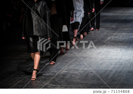 Fashion model on a runway during the fashion show. Fashion week themed photograph. 71154808