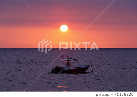 Sunset over Madagascar Nosy be beach with boat silhouette Sunset over Madagascar Nosy be beach with boat silhouette 71156220