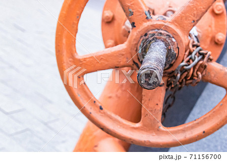 orange iron valve for regulating water flow vertical close-up 71156700