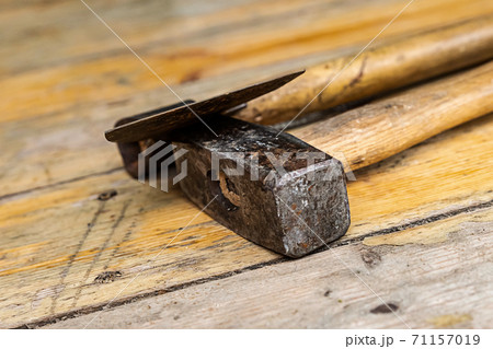 hammer and ax a pair of engineer tools on the boards close-up hammer and ax a pair of engineer tools on the boards close-up 71157019