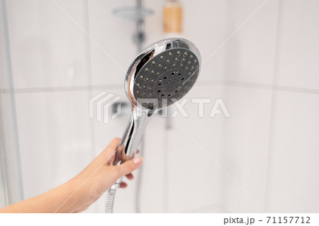 Chrome plated shower head, shower treatments. The girl takes a shower. Shower accessories Chrome plated shower head, shower treatments. The girl takes a shower. Shower accessories 71157712