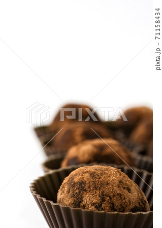 Delicious chocolate truffles with cocoa dusted isolated on white background 71158434
