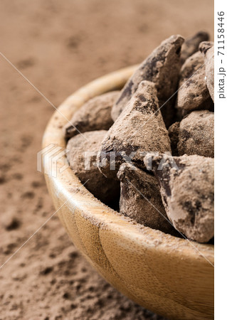 Homemade chocolate truffles in a wooden bowl	 71158446