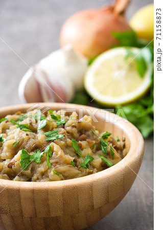 Eggplant baba ganoush and ingredients on wooden table Eggplant baba ganoush and ingredients on wooden table 71158873