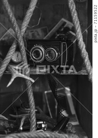 Vintage film camera and old photographs in the old, wooden crate 71159522