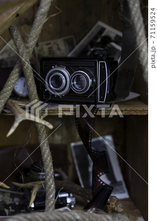 Vintage film camera and old photographs in the old, wooden crate 71159524
