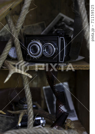 Vintage film camera and old photographs in the old, wooden crate 71159525
