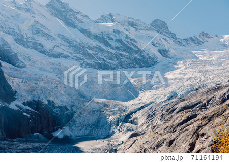 Rocky mountains and glacier. Peak of mountain and ice glacier in Dombay 71164194