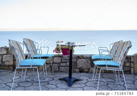 Empty restaurant terrace table in Afitos, Halkidiki, Greece Empty restaurant terrace table in Afitos, Halkidiki, Greece 71165783