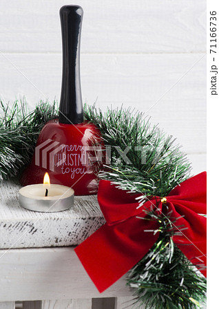 Chritmas red bow, bell and lit candle 71166736