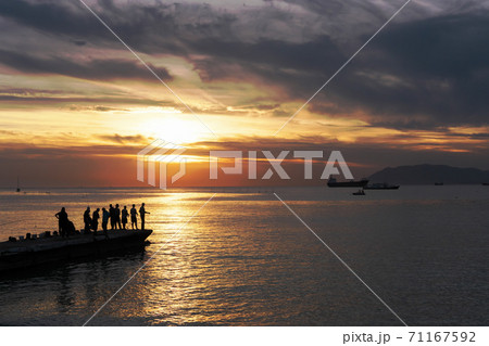 fishermen silouettes on sunset background. 71167592
