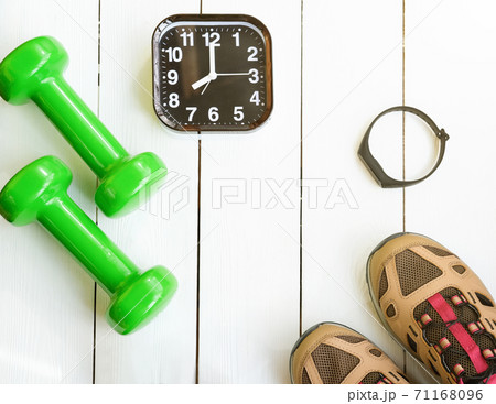 Time for exercising concept. alarm clock and dumbbells Time for exercising concept. alarm clock and dumbbells 71168096