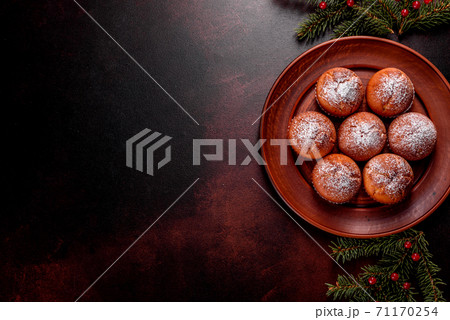 Beautiful delicious fresh cocoa muffins on the Christmas table Beautiful delicious fresh cocoa muffins on the Christmas table 71170254