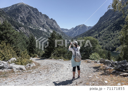 Young tourist woman take a picture from mountain with mobile phone Young tourist woman take a picture from mountain with mobile phone 71171855