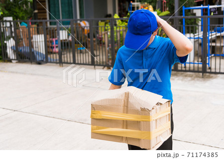Delivery man he emotional courier hold damaged cardboard box is broken Delivery man he emotional courier hold damaged cardboard box is broken 71174385