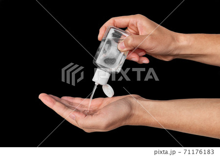 Portable small hand sanitizer bottle. Woman using to go dispenser for clean hands while commuting or shopping 71176183