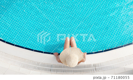 Woman relaxing in swimming pool Woman relaxing in swimming pool 71180055