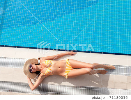 Woman relaxing in swimming pool Woman relaxing in swimming pool 71180056