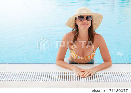 Woman relaxing in swimming pool 71180057