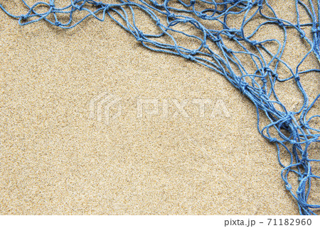 Blue Fishing net on a beach sand, travel concept Blue Fishing net on a beach sand, travel concept 71182960
