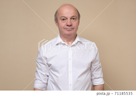 Elegant senior bald man smiling confident at camera. Elegant senior bald man smiling confident at camera. 71185535