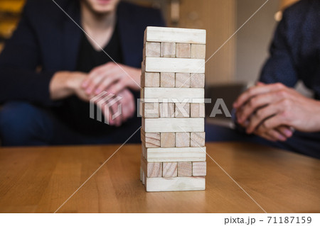 Guys play board game in a stylish loft cafe with a modern design Guys play board game in a stylish loft cafe with a modern design 71187159